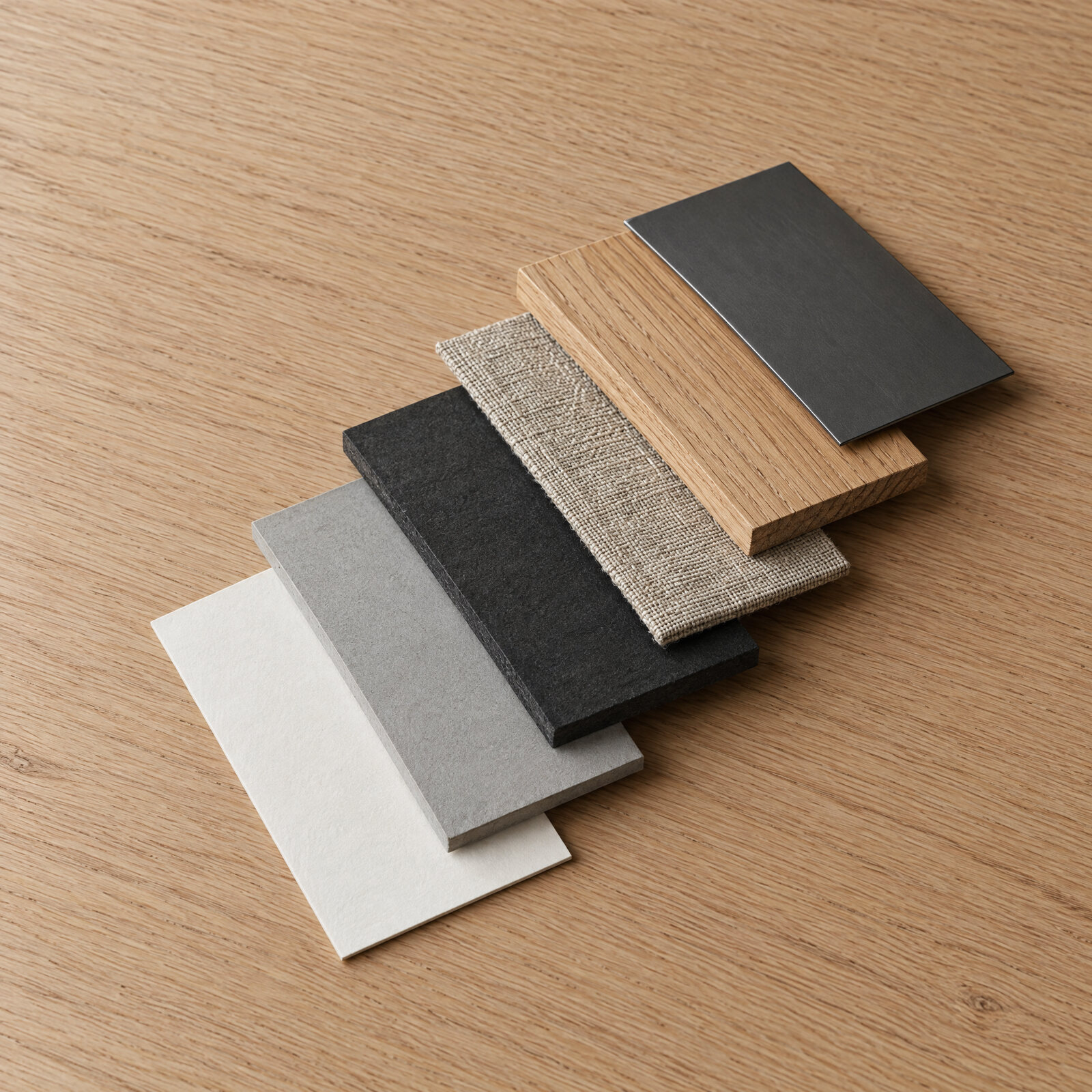 Material samples stacked in steps: paper, board, wood, canvas